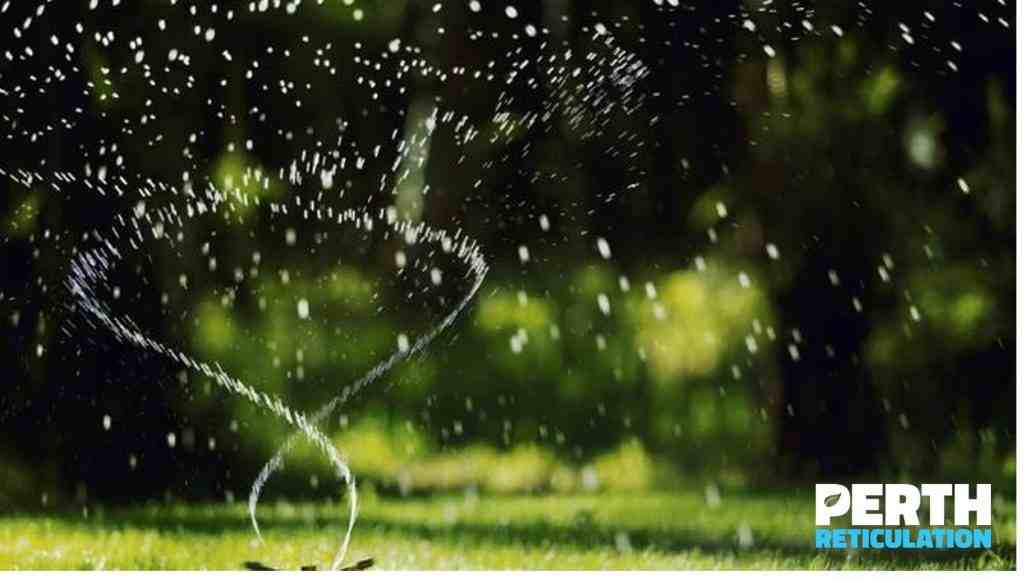 Lawn Water Sprinkler Spraying Water Over Grass In Garden