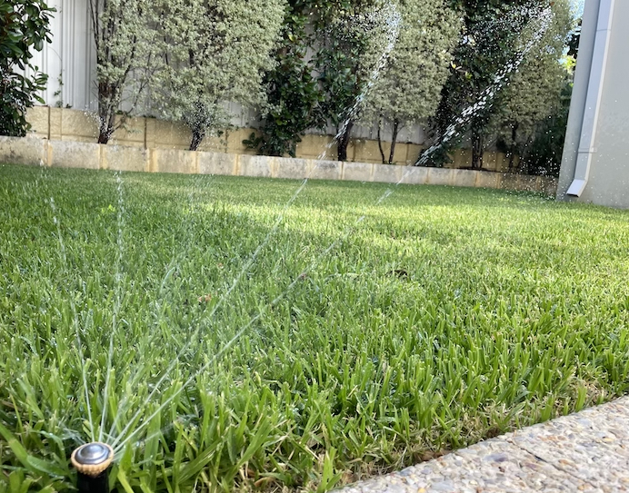new reticulation sprinkler system watering back lawn