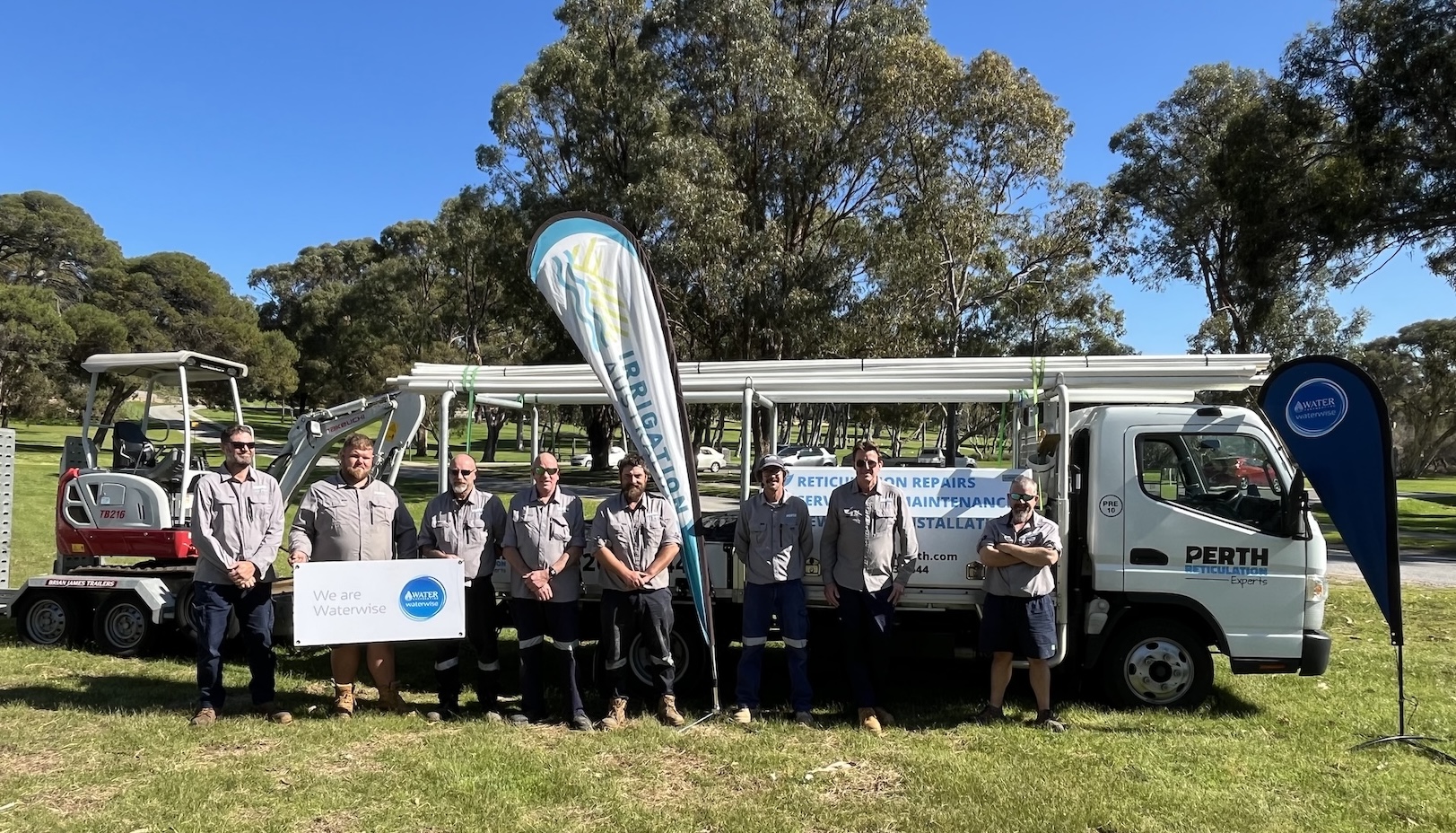 reticulation company team in front of installation vehicles